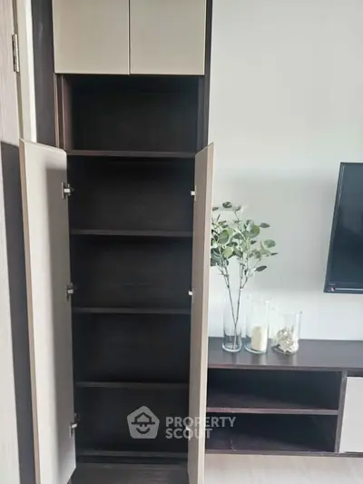 Modern living room with open storage cabinet and stylish decor