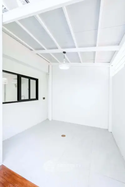 Bright and airy room with modern white interior and large window