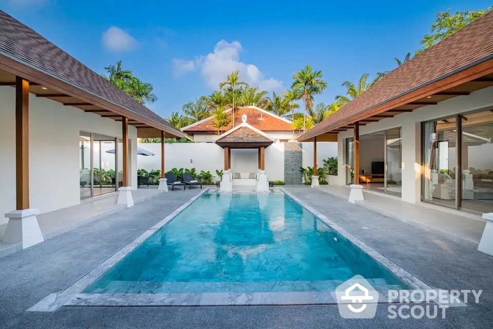 Luxurious villa with stunning pool and tropical garden setting, perfect for relaxation and entertainment.