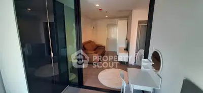 Modern living room with glass partition and stylish furniture