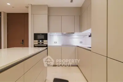 Modern kitchen with sleek cabinetry and built-in appliances in a luxury apartment.