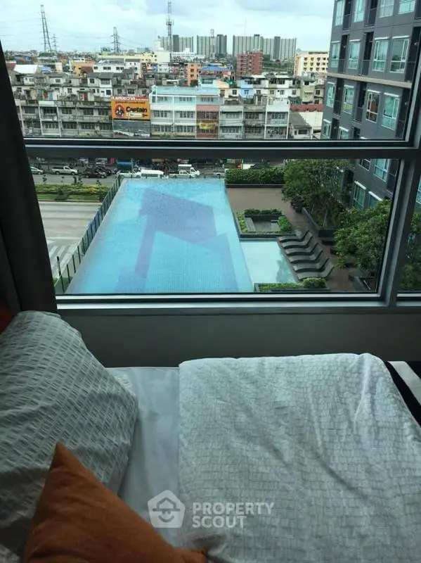 Luxurious bedroom with stunning pool view in modern high-rise apartment