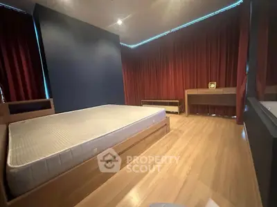 Spacious bedroom with modern design and wooden flooring