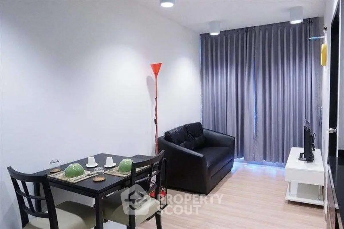 Modern living room with cozy seating and dining area, featuring sleek furniture and ambient lighting.