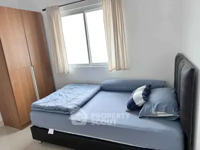 Cozy bedroom with natural light and modern furnishings, perfect for restful nights.