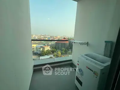Charming balcony with city view and washing machine, perfect for urban living.