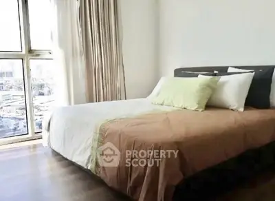 Bright bedroom with large window and modern decor