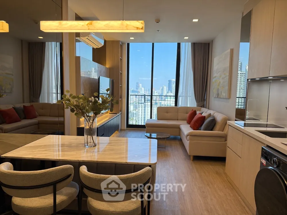 Luxurious modern living room with city view, open layout, and elegant furnishings.