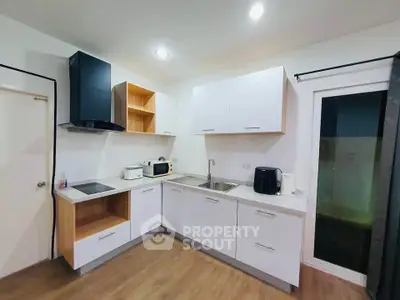 Modern kitchen with sleek cabinetry and appliances, featuring a minimalist design and ample counter space.