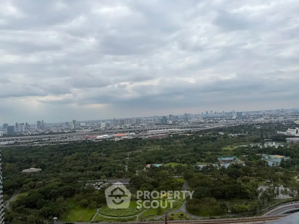 Stunning cityscape view from high-rise building overlooking lush green park and skyline.
