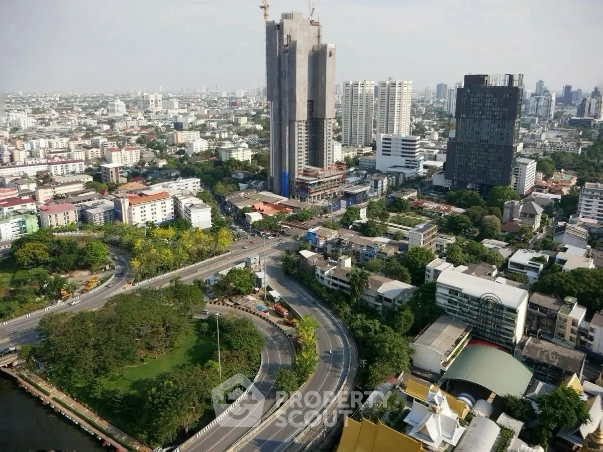 Stunning aerial view of urban cityscape with high-rise buildings and lush greenery, ideal for real estate investment.