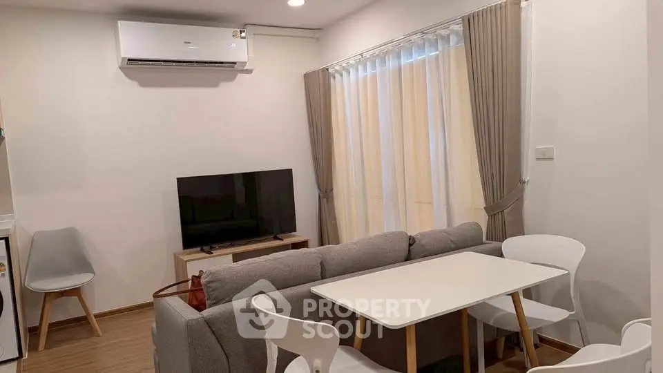 Cozy living room with modern furniture and natural light, perfect for relaxation and entertainment.