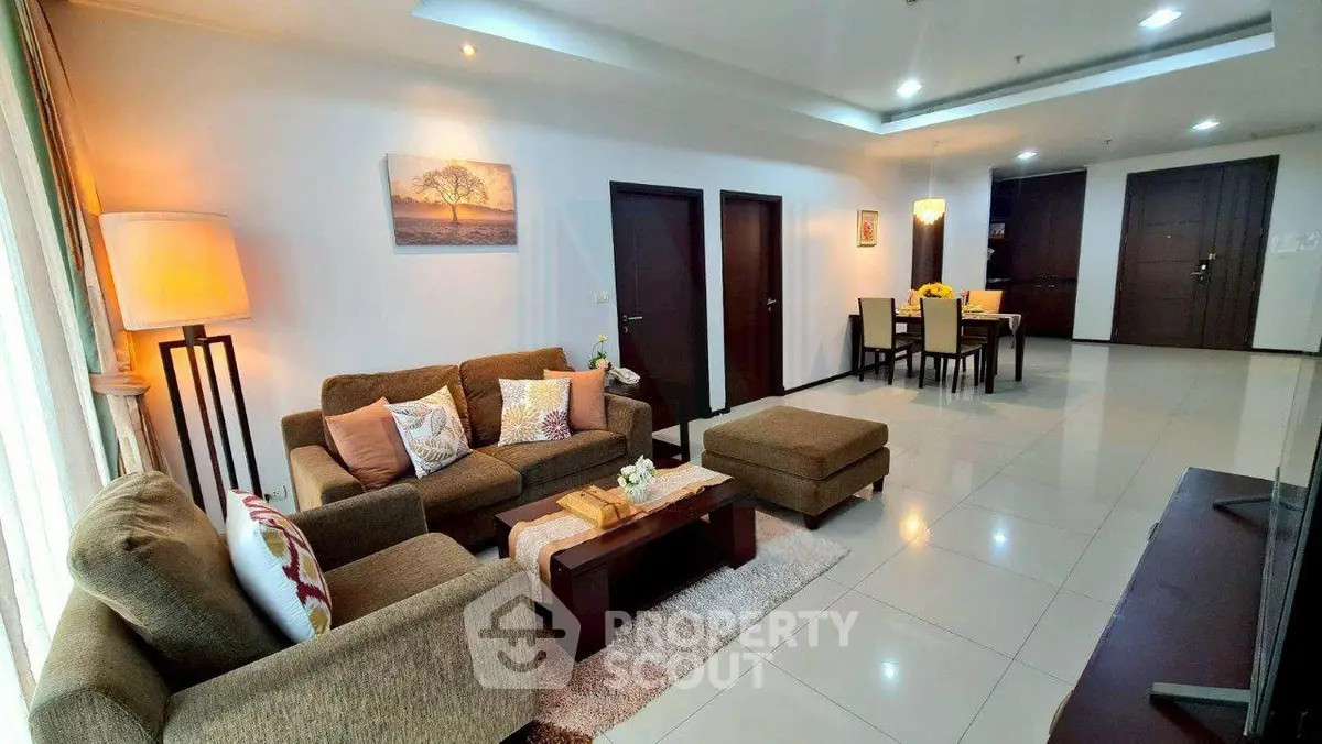 Spacious modern living room with elegant decor and dining area in open layout.