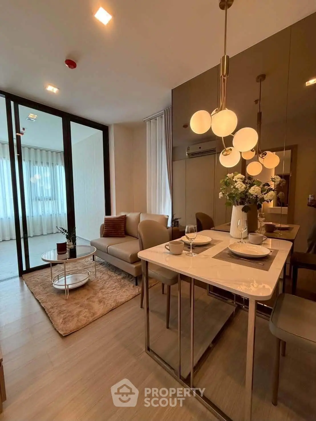 Modern living room with elegant dining area and stylish lighting in a contemporary apartment.