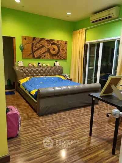 Cozy bedroom with vibrant green walls and modern decor