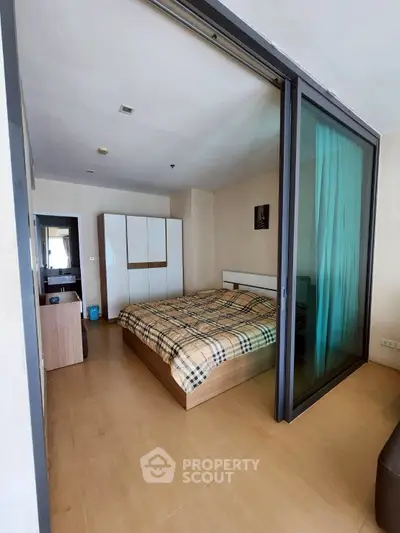 Modern bedroom with sliding glass doors and stylish decor