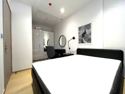 Modern bedroom with sleek furniture and stylish decor, perfect for urban living.