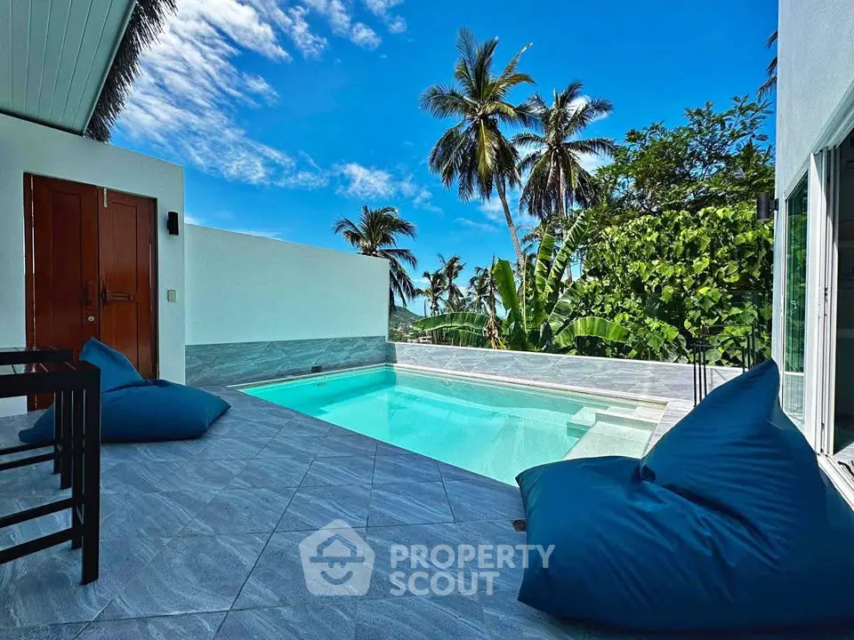 Luxurious tropical villa with private pool and stunning palm tree views.