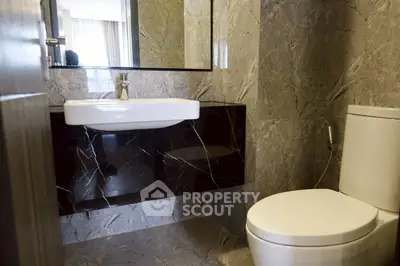 Modern bathroom with sleek marble tiles and contemporary fixtures
