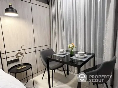 Modern dining nook with elegant decor and cozy seating in a stylish apartment.