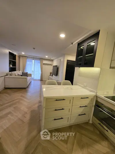 Modern open-plan living room with stylish kitchen and elegant decor.