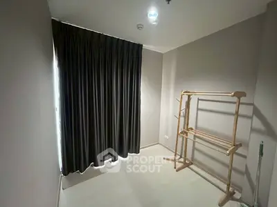 Minimalist room with dark curtains and wooden rack, perfect for storage or small office space.