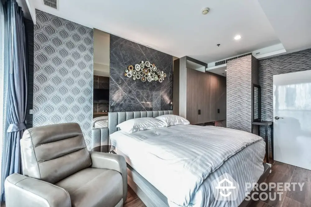 Luxurious modern bedroom with stylish decor and large windows offering natural light and a cozy ambiance.