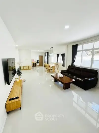 Spacious modern living room with sleek furniture and large windows