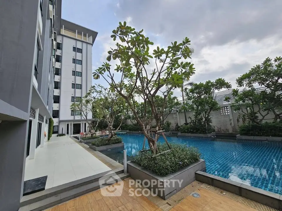 Luxurious condominium with serene poolside and lush greenery, perfect for relaxation and leisure.