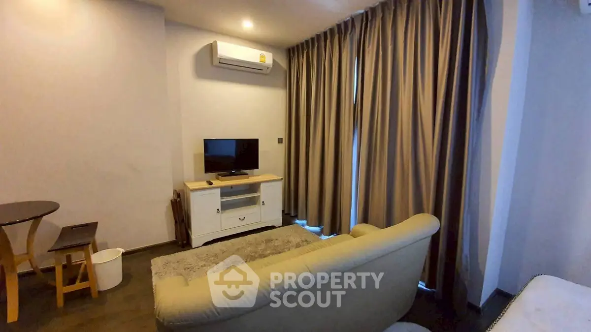 Cozy living room with modern air conditioning and stylish curtains