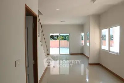 Spacious modern living room with large windows and natural light