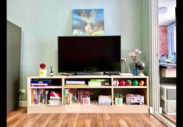 Stylish living room with modern TV stand and decor, showcasing a cozy and inviting atmosphere.