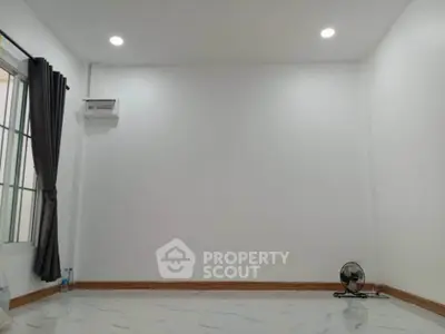 Spacious empty room with white walls and marble floor, ideal for customization.