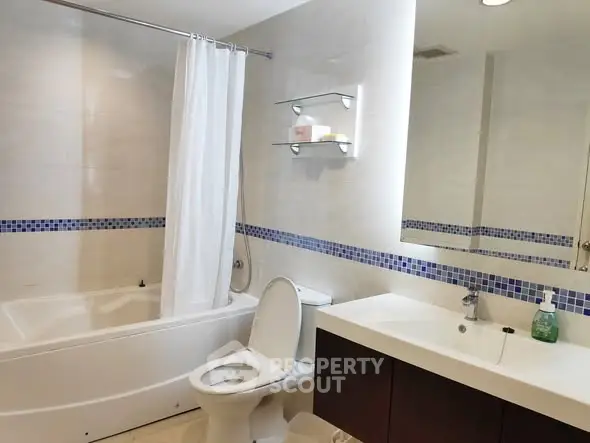Modern bathroom with bathtub and sleek fixtures in a stylish apartment.