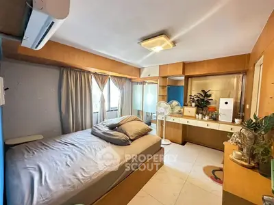 Cozy bedroom with modern decor and ample natural light