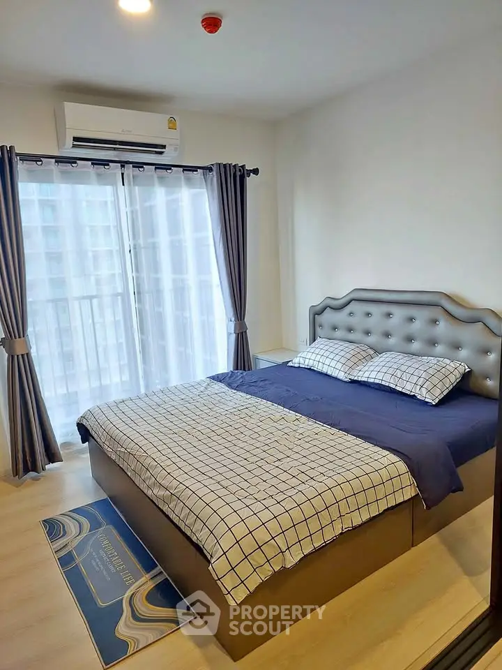 Modern bedroom with stylish decor and natural light from large windows.