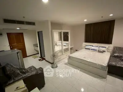 Spacious bedroom with modern furnishings and ample storage in a cozy apartment.
