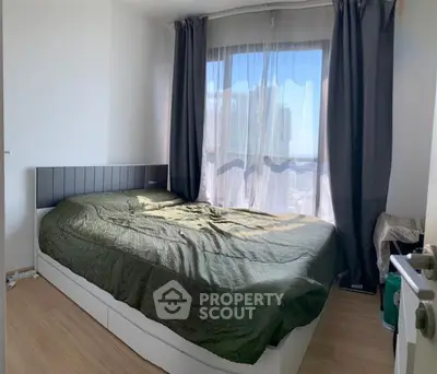 Cozy bedroom with large window and modern decor