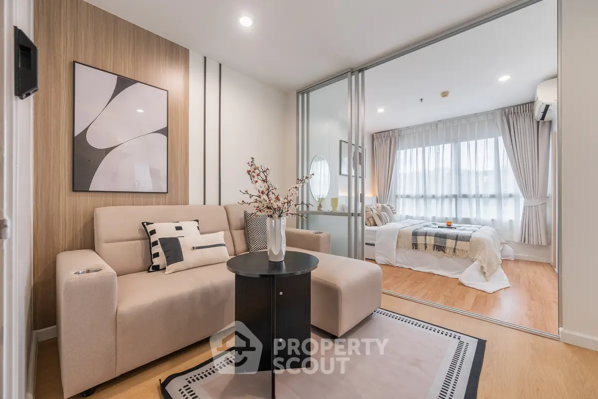 Modern living room with stylish decor and cozy bedroom view in a chic apartment.