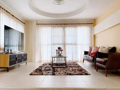 Spacious living room with modern decor and large windows for natural light.