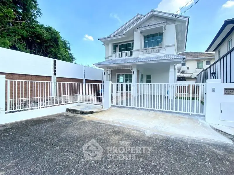 Stunning two-story house with modern design and spacious driveway in a serene neighborhood.