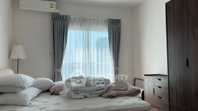 Cozy bedroom with natural light and modern furnishings