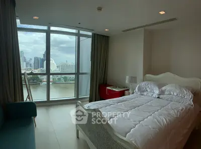 Spacious bedroom with stunning city view and elegant furnishings in modern apartment.