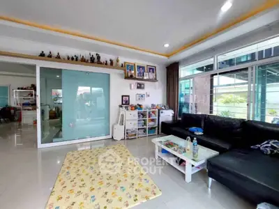 Spacious living room with modern decor and large windows for natural light.