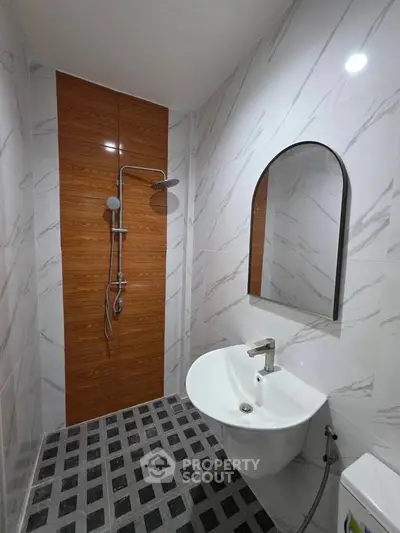 Modern bathroom with sleek shower and stylish sink in contemporary design.