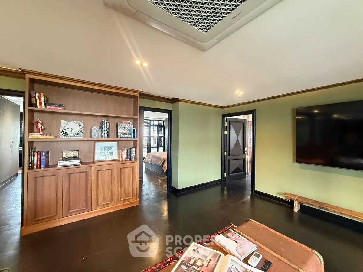 Spacious living room with elegant wooden bookshelf and modern decor