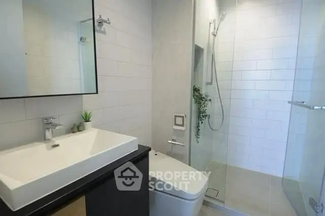 Modern bathroom with sleek fixtures and glass shower enclosure