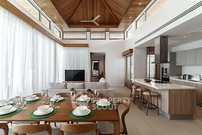 Luxurious open-plan living and dining area with high ceilings and modern kitchen.