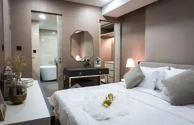 Luxurious bedroom with ensuite bathroom and walk-in closet, featuring elegant decor and ambient lighting.