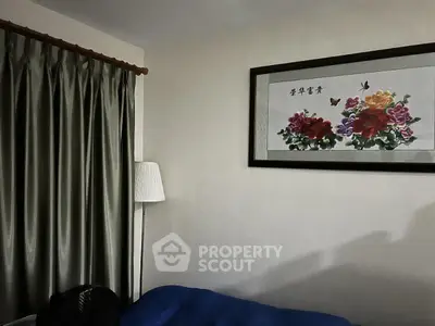 Cozy bedroom with elegant curtains and floral wall art, perfect for relaxation.